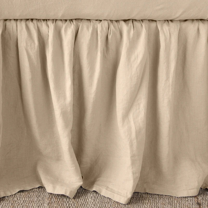 Bella Notte linen bed panel with a twin-sized bed skirt featuring a soft, elegant autumn-colored fabric and tailored design.