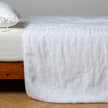 White Bella Notte Ines Bedspread spread over a king-size bed, showcasing elegant, soft fabric and detailed stitching.