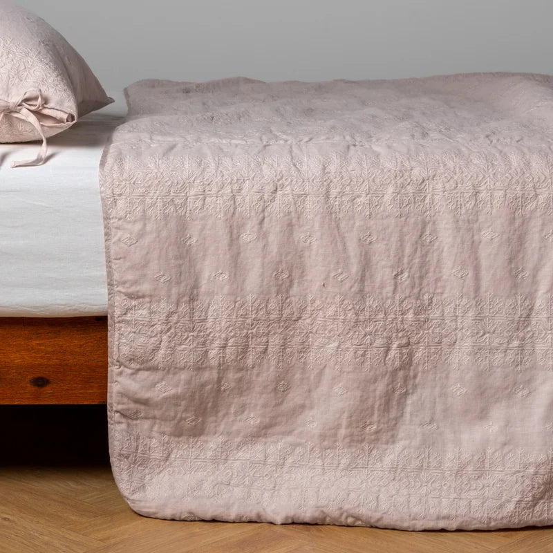 White Bella Notte Ines bedspread spread out on a bed, showcasing its soft fabric and elegant design for a king-size bed.