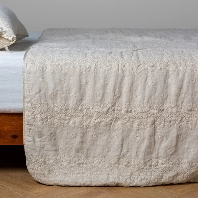 White Bella Notte Ines Bedspread spread smoothly on a king-sized bed, showcasing soft, luxurious fabric and elegant design.