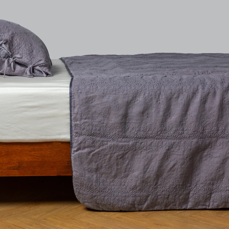 White Bella Notte Ines Bedspread spread over a king-size bed, showcasing soft fabric and elegant design.