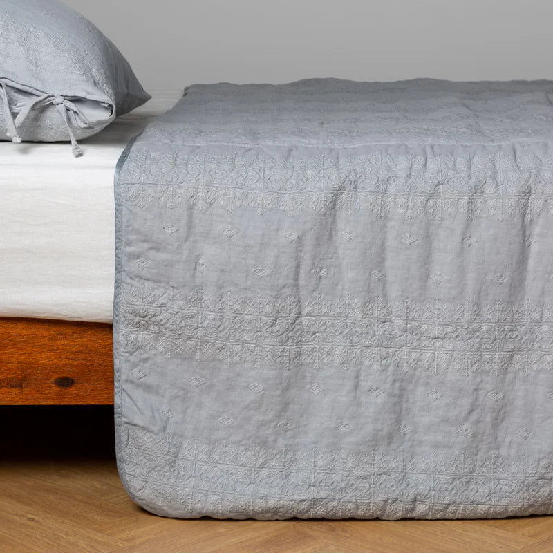 White Bella Notte Ines bedspread draped over a king-sized bed, showcasing soft, luxurious fabric and elegant design.