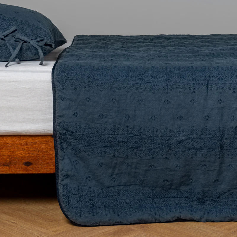 White Bella Notte Ines Bedspread spread across a bed, showcasing soft, luxurious fabric and elegant design for king-sized bedding.