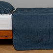 White Bella Notte Ines Bedspread spread across a bed, showcasing soft, luxurious fabric and elegant design for king-sized bedding.