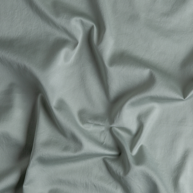 Bella Notte Bria duvet cover in Cenote fabric displayed on a bed, showcasing its soft, luxurious texture and elegant design.