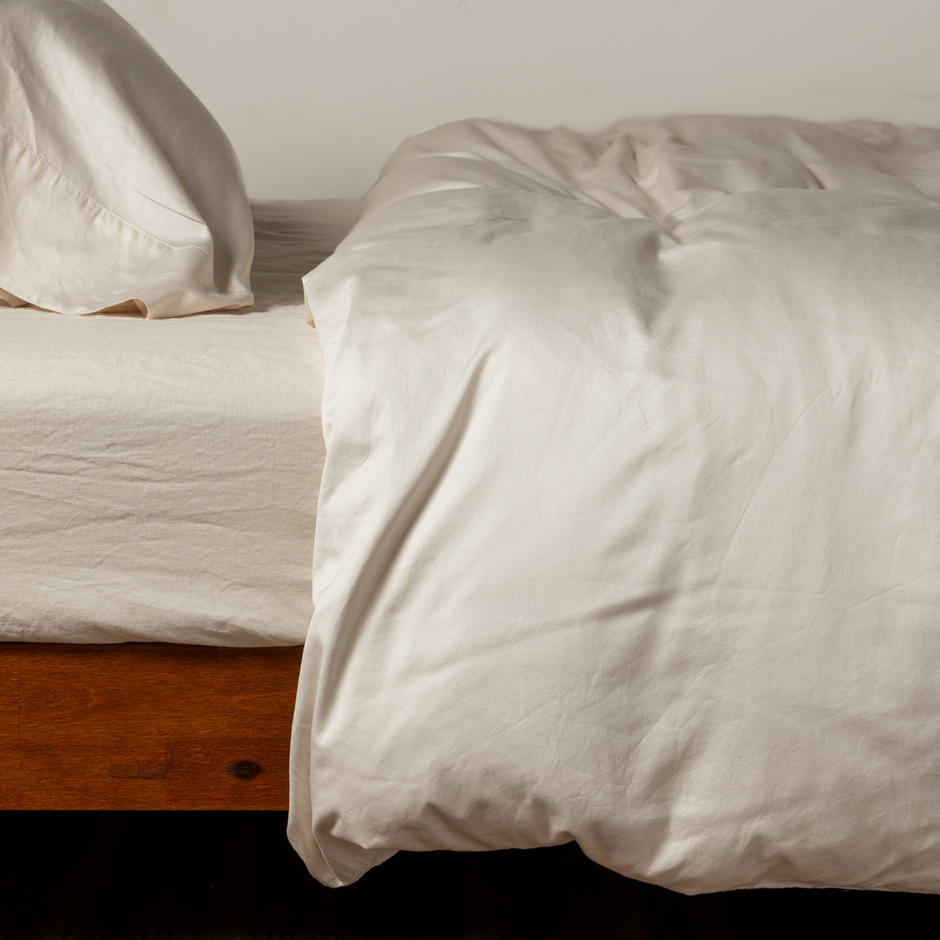 Natural Bella Notte Bria duvet cover displayed on bed, showcasing soft fabric and elegant design in a neutral tone.