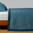 Bella Notte Cirillo Coverlet in autumn color, showcasing soft fabric and elegant design on a bed.