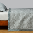 Bella Notte Cirillo coverlet in autumn colors, showcasing soft fabric and elegant design on a bed.