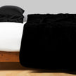 Bella Notte silk velvet quilted coverlet in autumn color, showcasing its luxurious, quilted texture on a twin bed.