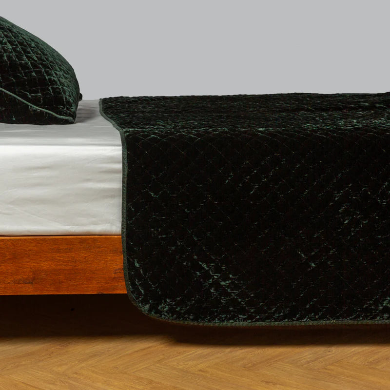 Bella Notte silk velvet quilted coverlet in autumn tones, showcasing plush, quilted fabric with elegant stitching details.
