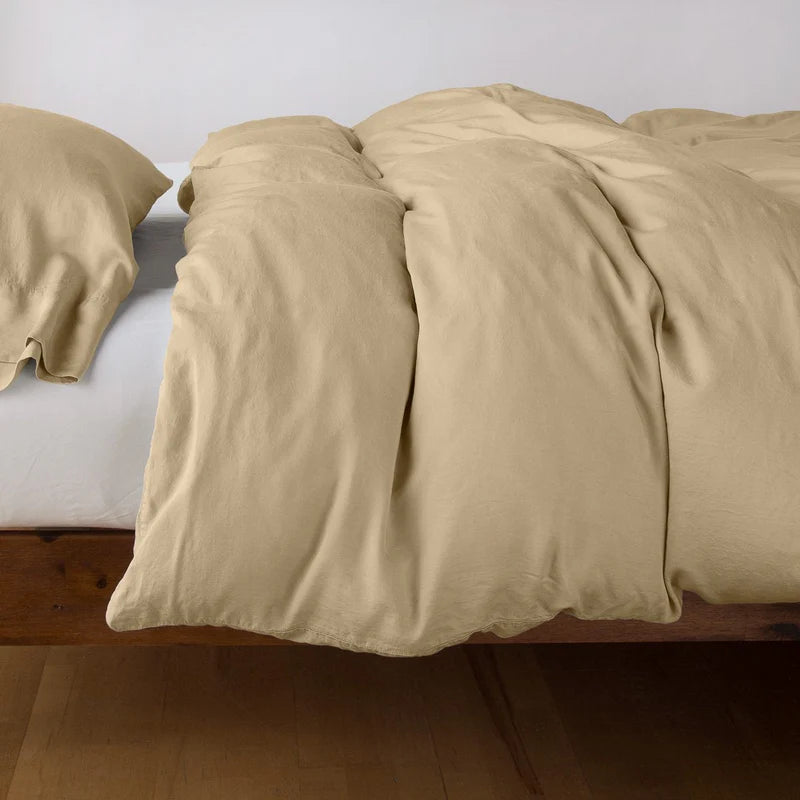 Bella Notte Madera Luxe duvet cover in cloud color, soft and luxurious fabric, shown on a neatly made king bed.