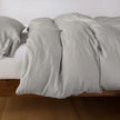 Bella Notte Madera Luxe duvet cover in cloud color, showcasing soft, luxurious fabric with elegant stitching for king-sized bedding.
