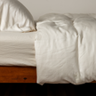 Natural-colored Bella Notte Madera Luxe duvet cover made of soft fabric, showcasing elegant, textured bedding design.
