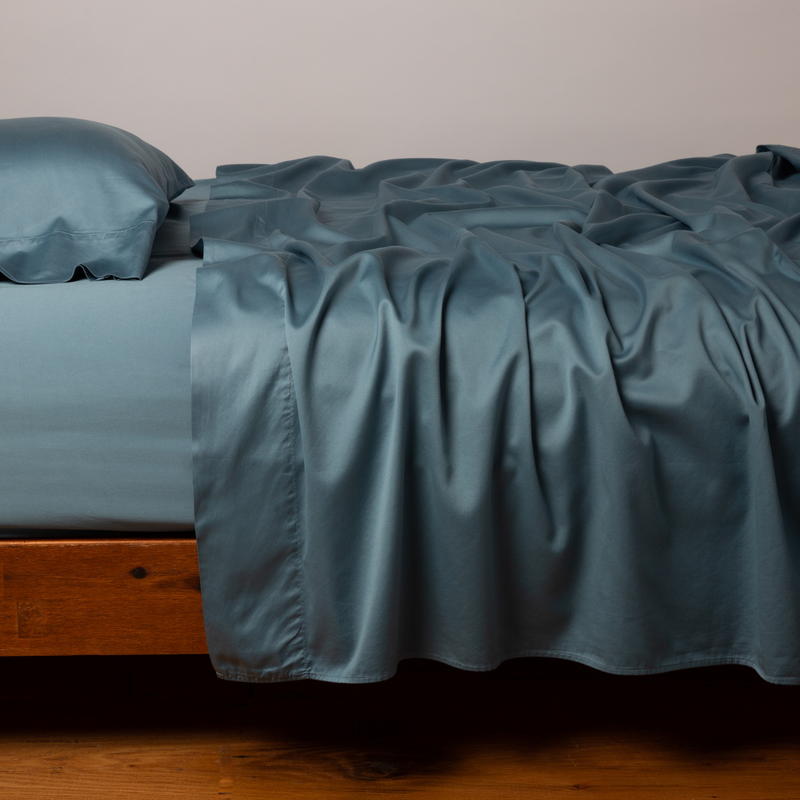 King Bella Notte Bria Flat Sheet in Cenote color, showing smooth, soft fabric with neatly folded edges.