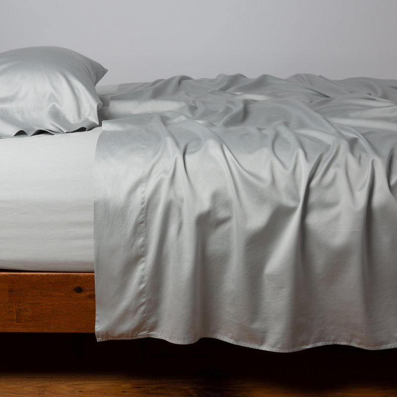 Bella Notte Cenote king flat sheet, smooth white bedding with elegant stitching details, made for luxurious bedroom decor.