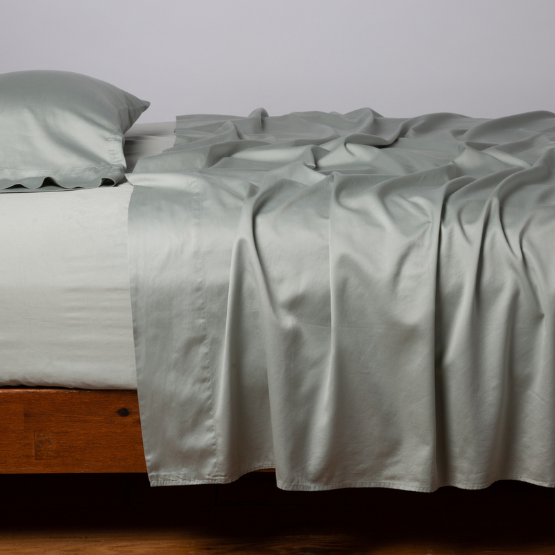 Bella Notte Cenote King Bria Flat Sheet displayed on bed, soft fabric with elegant, natural drape and subtle textured pattern.