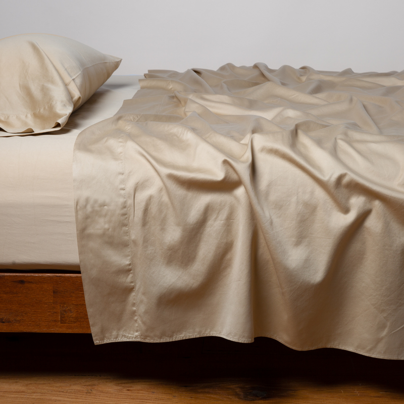 Bella Notte Cenote King Bria Flat Sheet shown spread on a bed with soft, luxurious fabric and elegant stitching details.