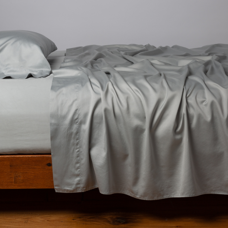 Bella Notte Cenote King Bria Flat Sheet in soft, luxurious fabric, shown spread smoothly on a bed.