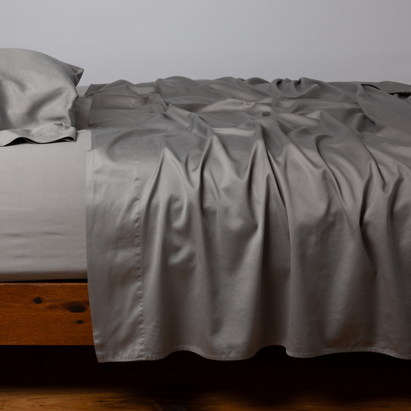 Bella Notte Cenote King Bria Flat Sheet in soft, luxurious fabric, laid out smoothly on a bed with a subtle texture.