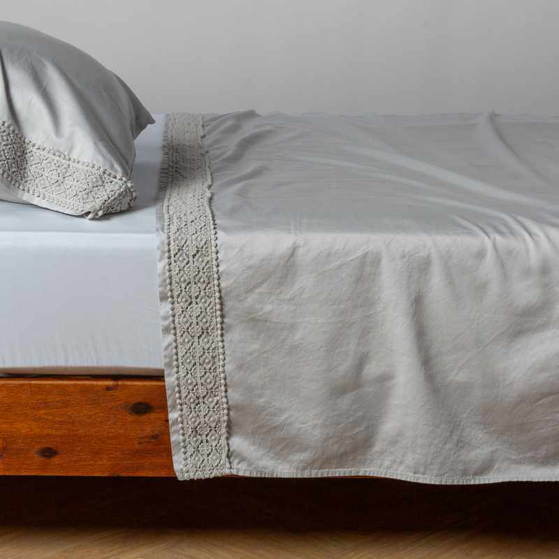 Bella Notte Bria flat sheet in Cenote with Novola lace, showcasing soft fabric and intricate lace details.