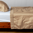 Bella Notte Bria flat sheet in Cenote with Novola lace detail, showcasing soft, luxurious fabric and elegant lace trim.
