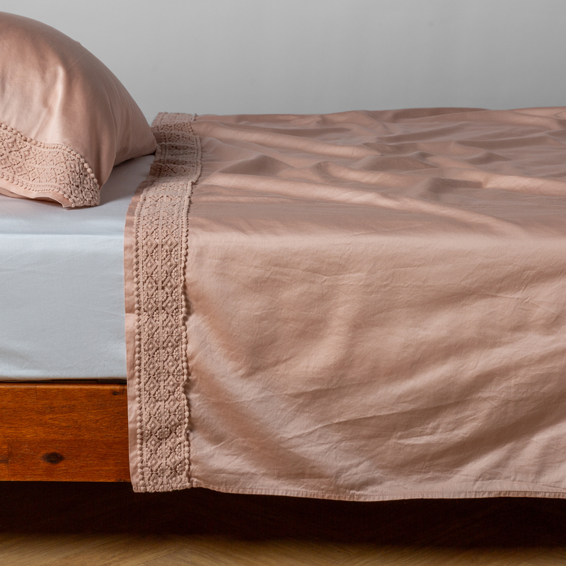 Bella Notte Bria flat sheet in Cenote with Novola lace, showcasing soft fabric and elegant lace detail on a king-sized bed.