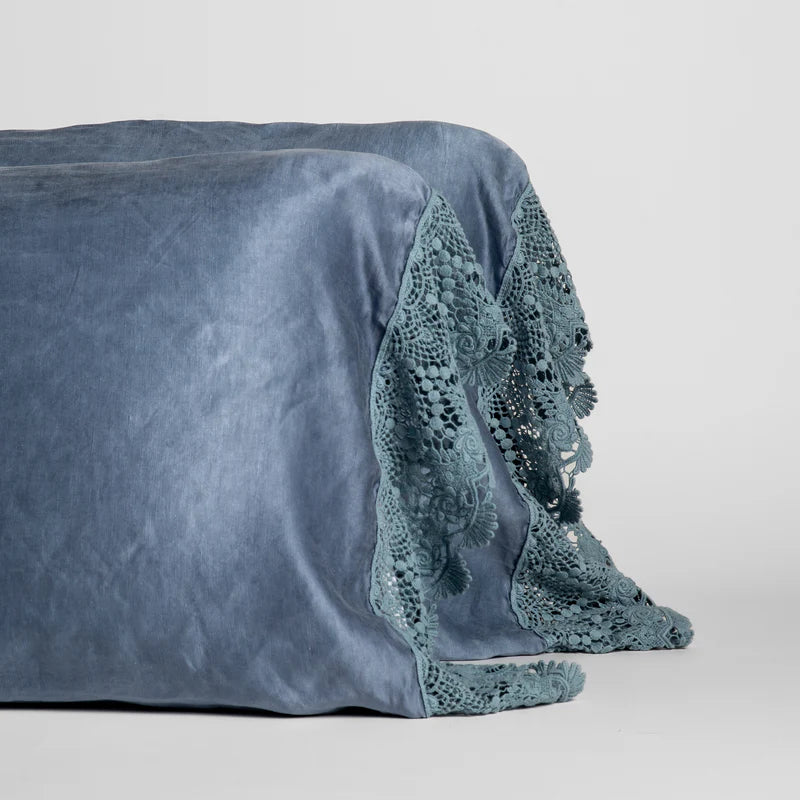 Bella Notte Paloma pillowcase with lace edge, featuring a soft fabric and elegant lace detail, set on a bed.