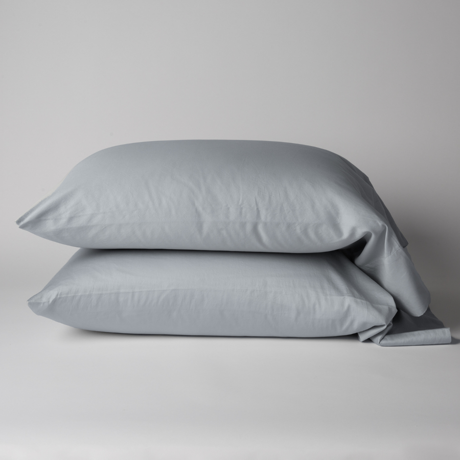 Bella Notte Bria cotton sateen pillowcase in soft cloud color, showing smooth fabric and elegant seam details.
