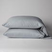 Bella Notte Bria cotton sateen pillowcase in soft cloud color, showing smooth fabric and elegant seam details.