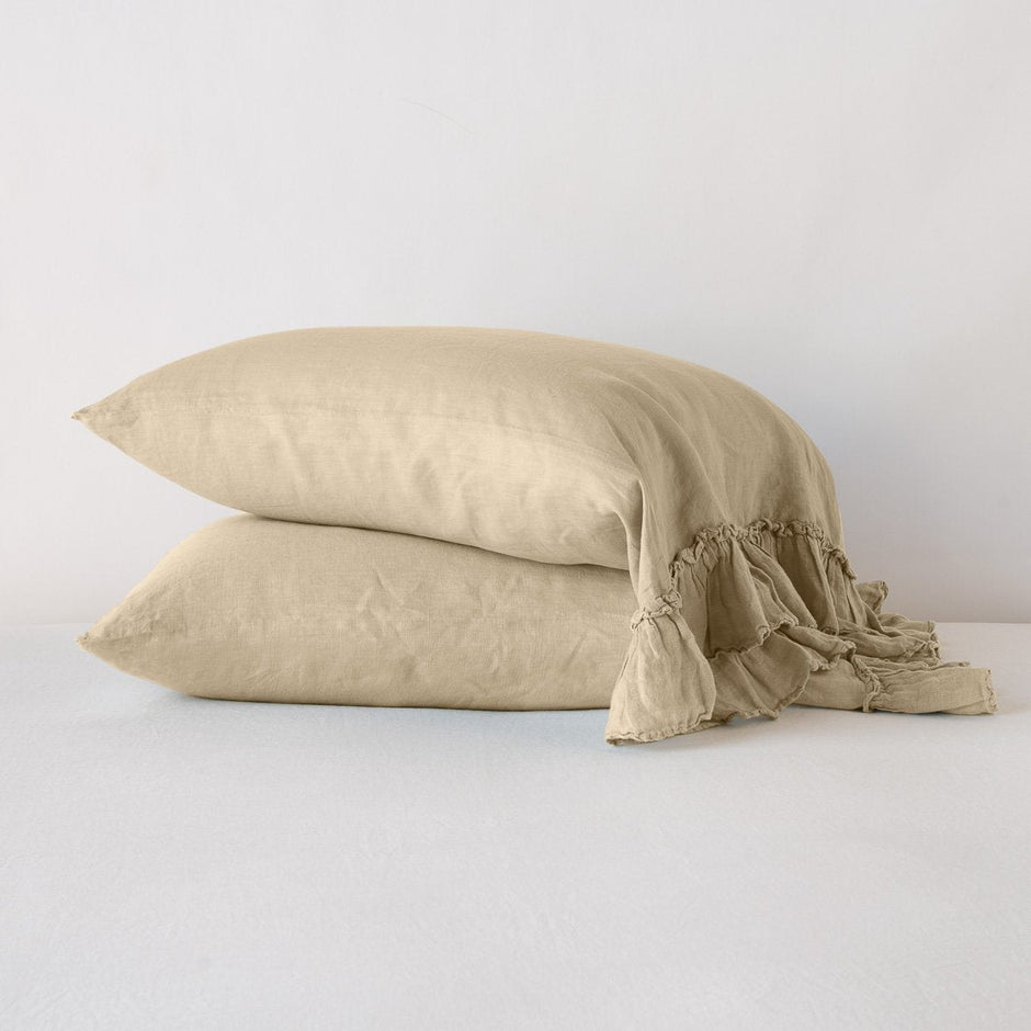 White Bella Notte Linen Whisper Pillowcase on a bed, showcasing soft, textured fabric and elegant design for a comfortable sleep.