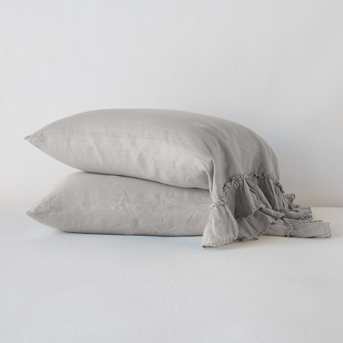 White linen Whisper Pillowcase by Bella Notte, showcasing smooth fabric and elegant stitching on a standard-sized pillow.