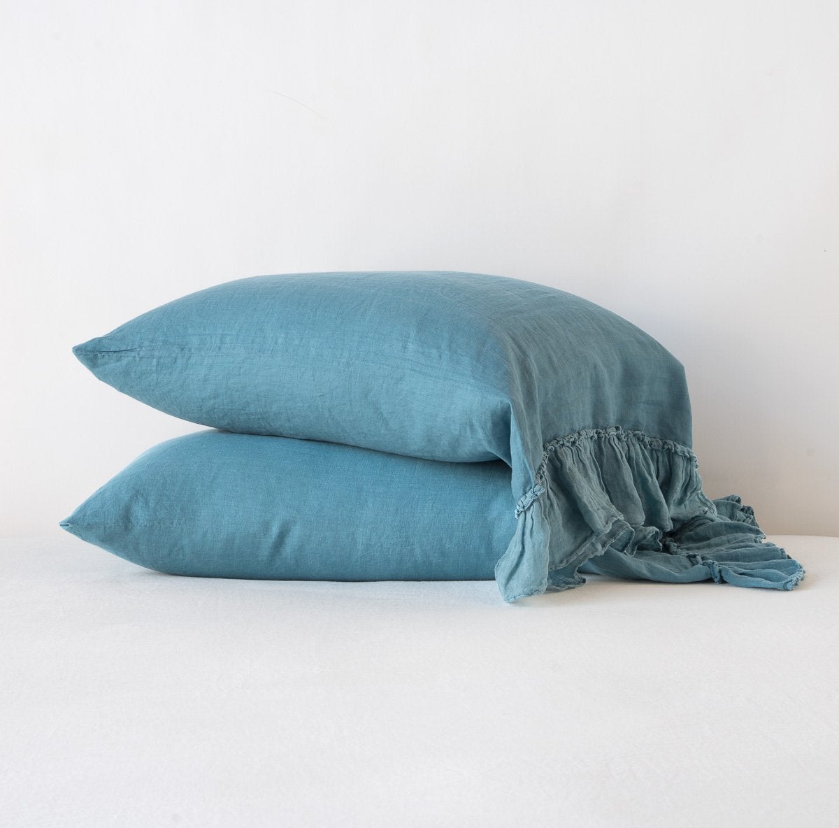 White Bella Notte Linen Whisper pillowcase shown on a bed, featuring soft fabric and elegant stitching for a luxurious look.