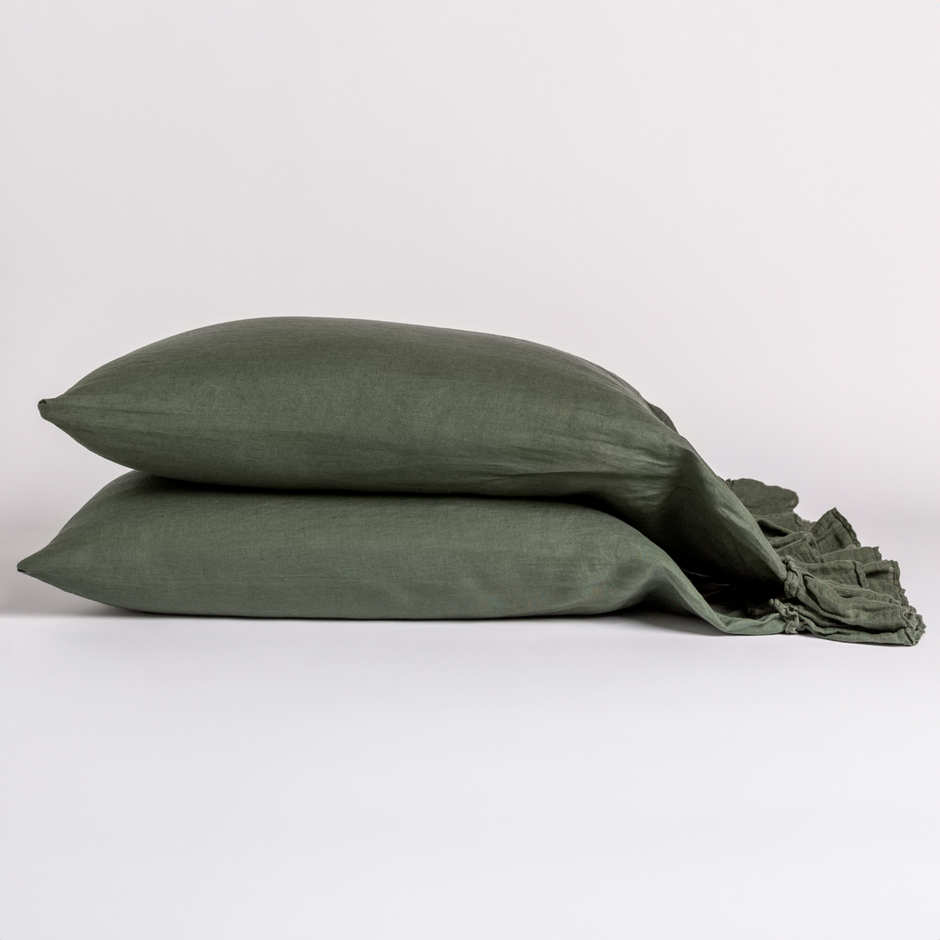 White Bella Notte Linen Whisper pillowcase on a bed, showcasing soft, luxurious fabric and elegant design.