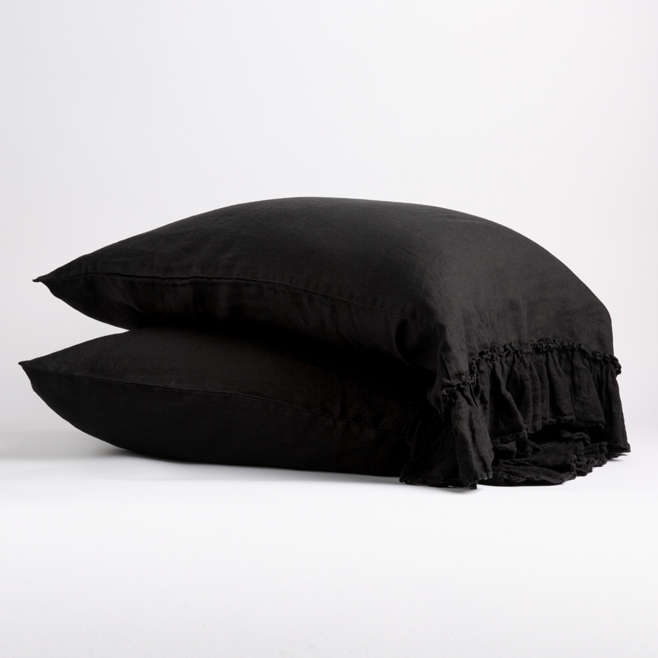 White Bella Notte Linen Whisper pillowcase on a bed, showing soft, crisp fabric and elegant stitching for a cozy, luxurious look.