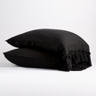 White Bella Notte Linen Whisper pillowcase on a bed, showing soft, crisp fabric and elegant stitching for a cozy, luxurious look.