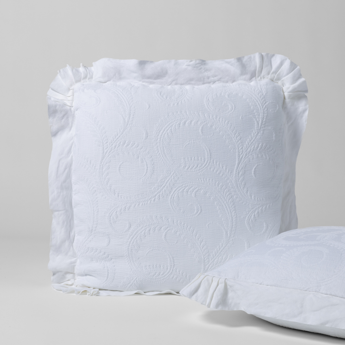 Bella Notte Marisette Sham in cloud color, showcasing luxurious fabric and elegant European-style design for a cozy bedroom look.