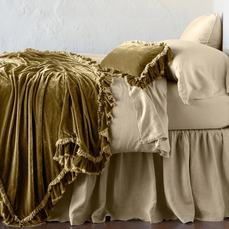Bella Notte Loulah throw blanket featuring soft, plush fabric in warm autumn tones, perfect for cozying up on the sofa.