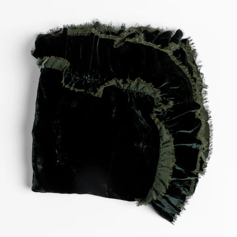 Bella Notte Loulah throw blanket in warm autumn colors, soft and cozy fabric, displayed on a neatly made bed.