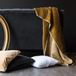 Bella Notte silk velvet quilted throw blanket featuring a luxurious, soft autumn-colored fabric with a stylish quilted pattern.