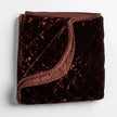 Bella Notte silk velvet quilted throw blanket with a soft, luxurious autumn-colored fabric and intricate quilting details.