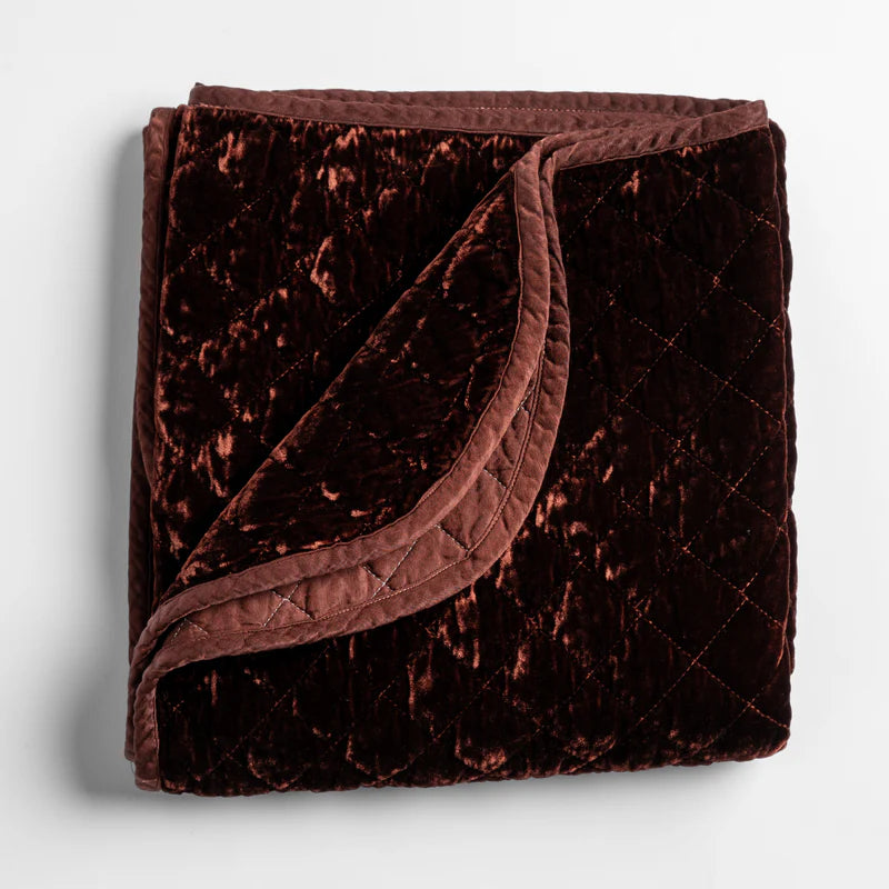 Bella Notte silk velvet quilted throw blanket with a soft, luxurious autumn-colored fabric and intricate quilting details.
