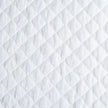 Bella Notte silk velvet quilted throw blanket with a cozy, luxurious design in warm autumn tones.