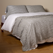 Bella Notte Allora Bed Scarf throw blanket with intricate Cenote pattern, draped over a bed for a cozy, elegant look.