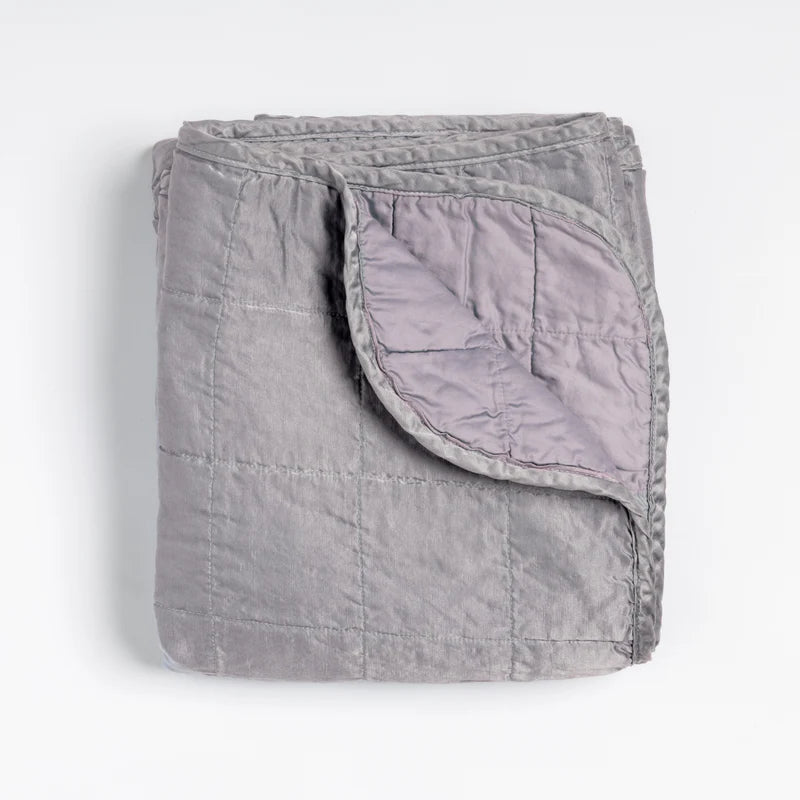 Bella Notte Tahoe Blue Sel Throw Blanket draped over a sofa, showcasing soft, cozy fabric and elegant design.