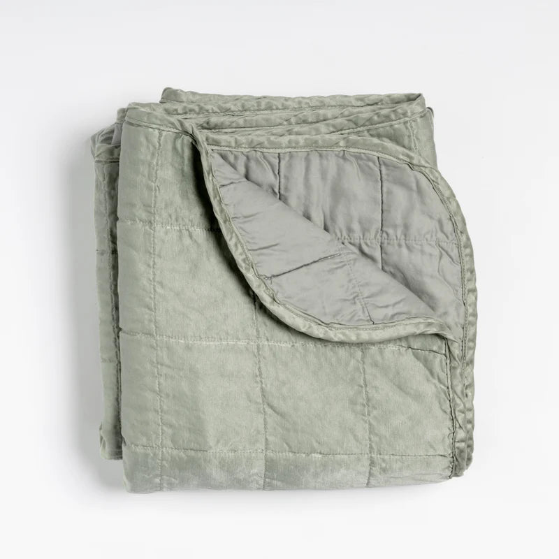 Bella Notte Tahoe Blue Sel Throw Blanket displayed on a cozy bed, showcasing soft, luxurious fabric and elegant design.