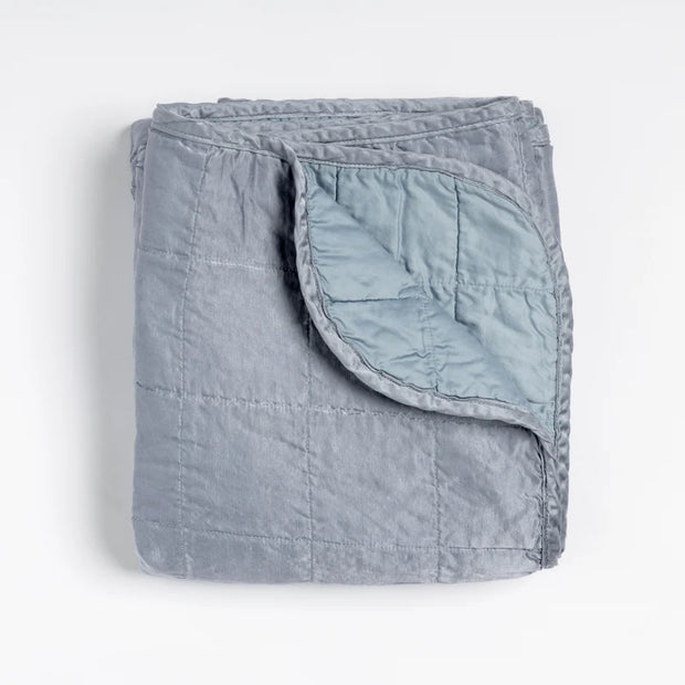 Bella Notte Tahoe Blue Sel throw blanket spread out on a cozy sofa, showcasing soft, luxurious fabric and elegant design.