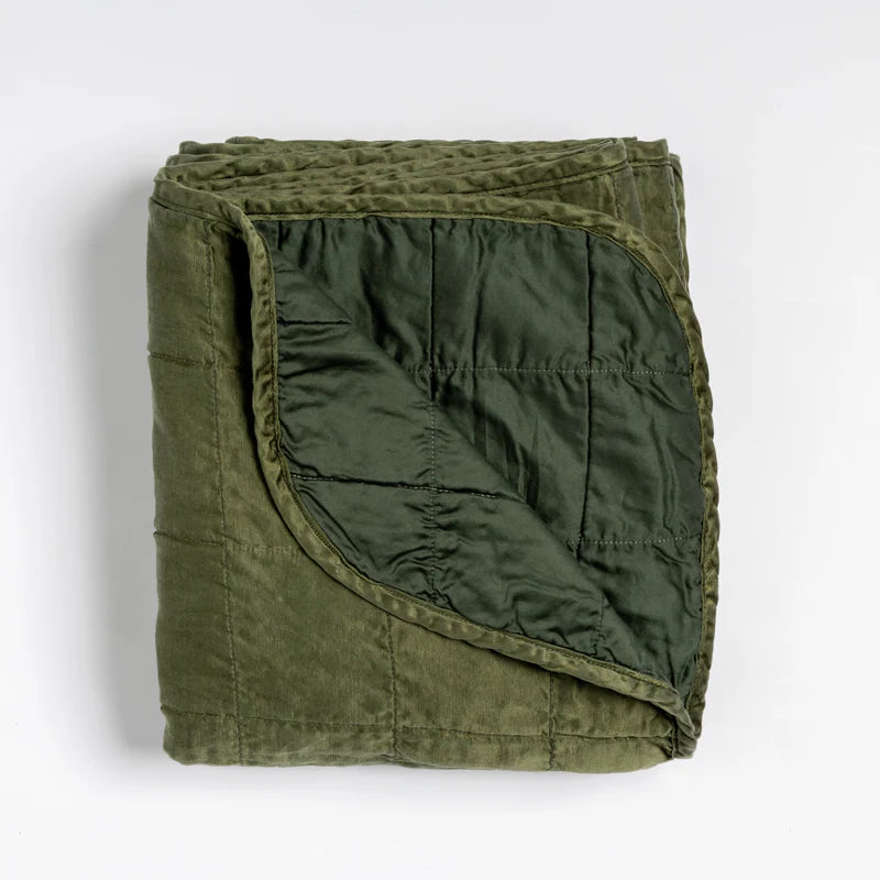 Bella Notte Tahoe Blue Sel Throw Blanket draped over a sofa, showcasing soft, cozy fabric and elegant design.