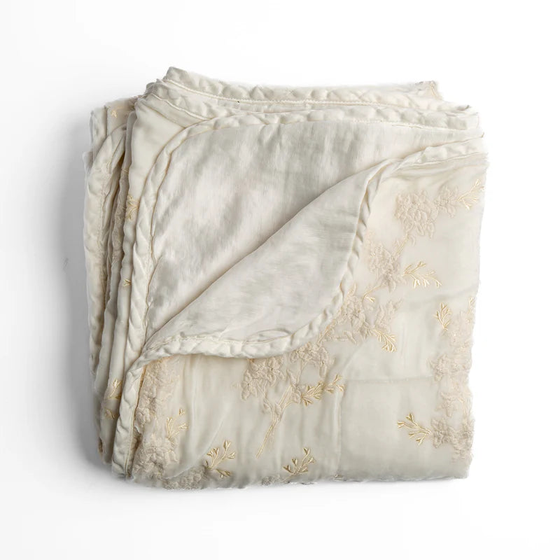 Bella Notte Lynette throw blanket in Tahoe Blue, soft and cozy fabric, draped over a sofa for a stylish, comfortable look.