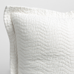 Bella Notte Cirillo throw pillow with autumn-colored fabric, showcasing soft texture and decorative design.