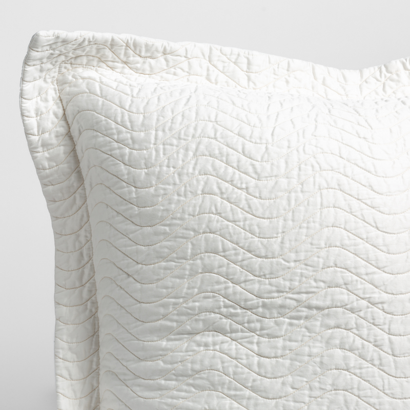 Bella Notte Cirillo throw pillow with autumn-colored fabric, showcasing soft texture and decorative design.